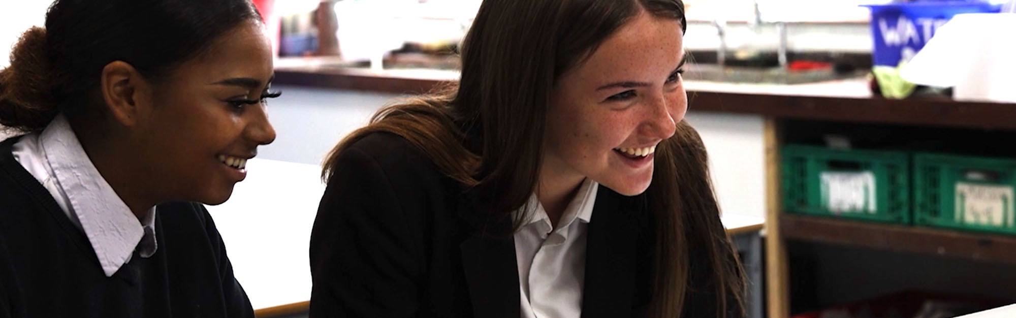 Image shows 2 pupils enjoying their class.