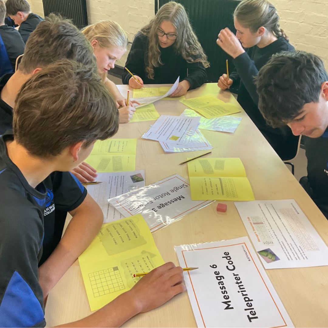 Image shows a group of pupils working together to decipher codes