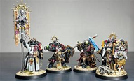 Image shows a 4 different painted Warhammer figures 