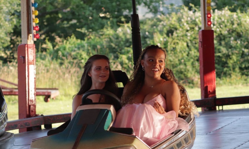 Image shows 2 Y11 pupils enjoying the dodgems during the 2024 Year 11 prom 